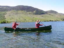 Paddling on the crystal clear waters of Crummockwater Lake District.